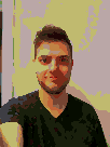 Michael Juskowicz as rendered with a Gameboy. The image has a green cast over it and features a highly pixelated silhoutte of a man.